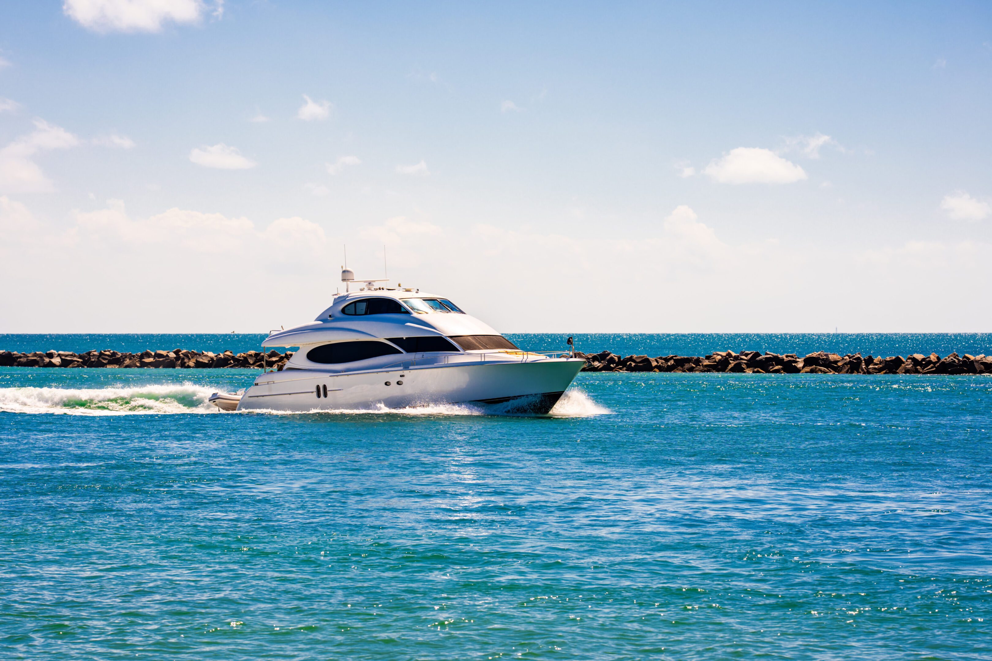 Luxury yacht cruising on blue ocean waters.